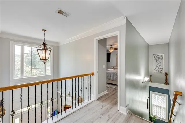 a view of a hallway with wooden floor and entryway