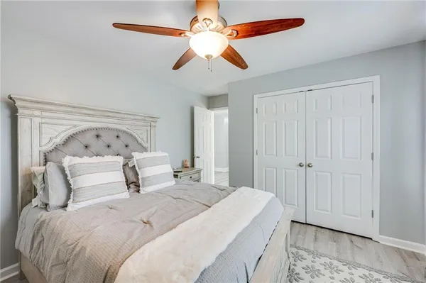 a bedroom with a bed and a chandelier