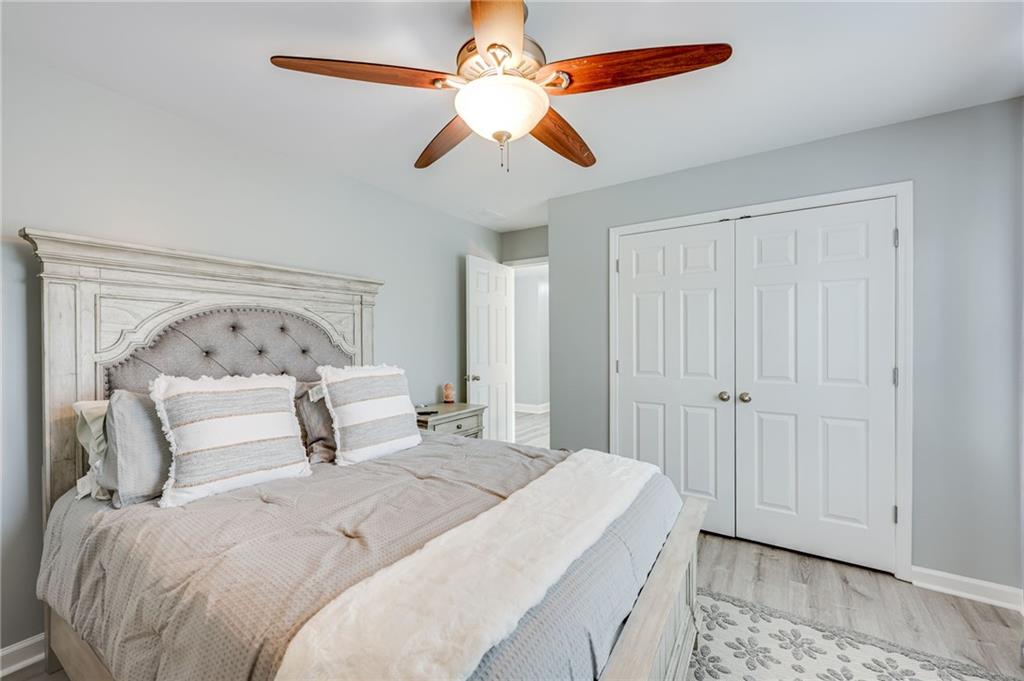 32 St Ives Circle Winder, GA 30680 - Photo 29 of 38 a bedroom with a bed and a chandelier