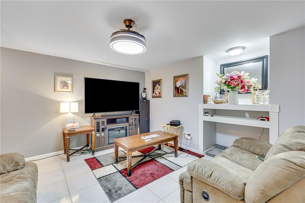 32 St Ives Circle Winder, GA 30680 - Photo 34 of 38 a living room with furniture and a flat screen tv