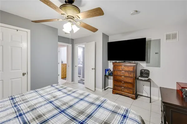 a bedroom with furniture and flat screen tv