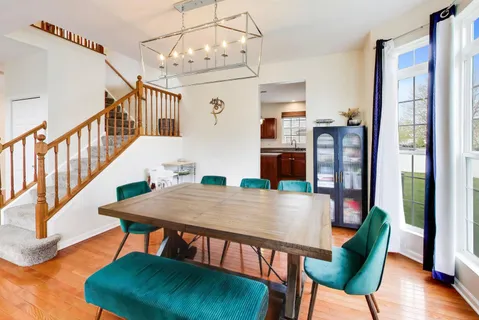 a kitchen with stainless steel appliances granite countertop a refrigerator a sink dishwasher a stove with wooden floors