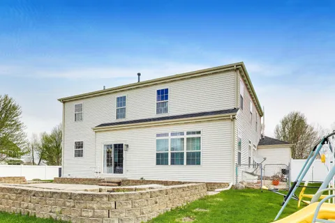 a view of an house with backyard space and garden