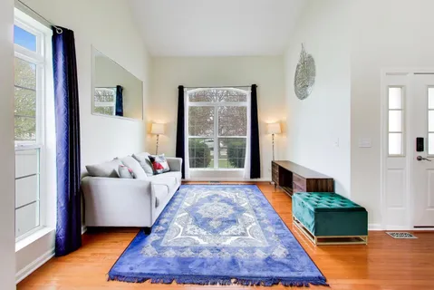 a living room with furniture and a rug