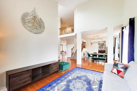 a dining room with furniture and wooden floor