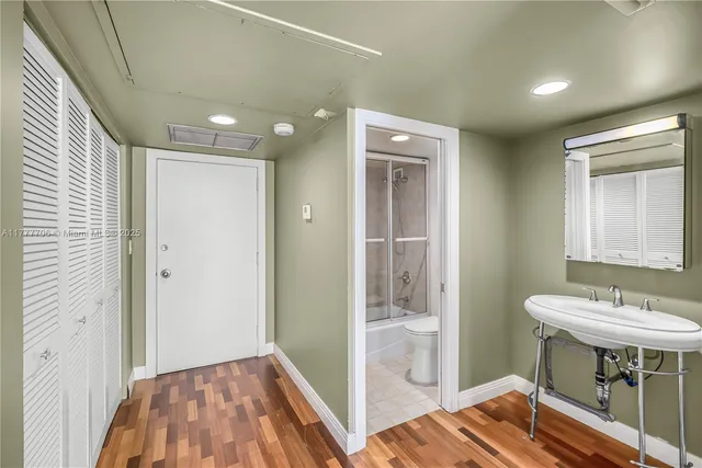 a view of a bathroom with sink mirror and shower