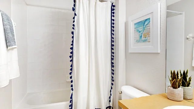 a bathroom with a bathtub and shower