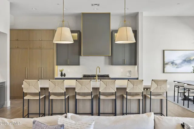 a kitchen with stainless steel appliances white cabinets and wooden floors