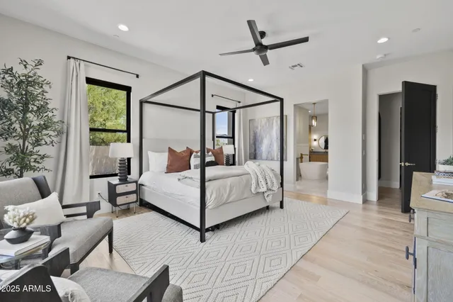 a bathroom with a tub sink and mirror