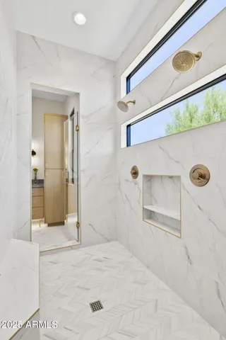 a bathroom with a granite countertop toilet sink and mirror