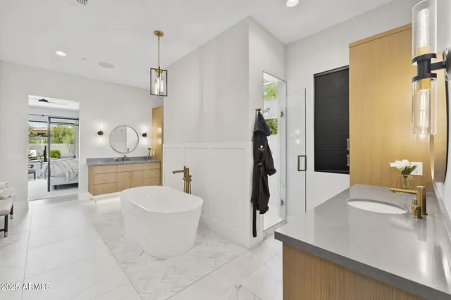 a kitchen with stainless steel appliances granite countertop a sink a stove and a microwave oven with white cabinets