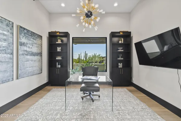 a bedroom with a bed and a chandelier