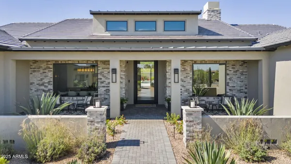 a view of a house with outdoor seating