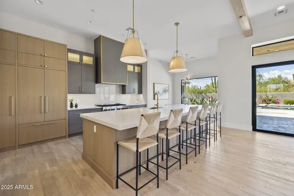 a large kitchen with stainless steel appliances granite countertop a stove and cabinets