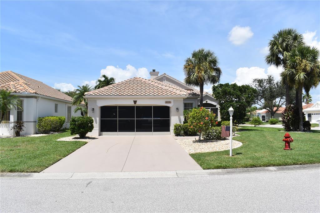 10251 Arrowhead Drive Punta Gorda, FL 33955 - Photo 1 of 1 a front view of a house with a garden and trees