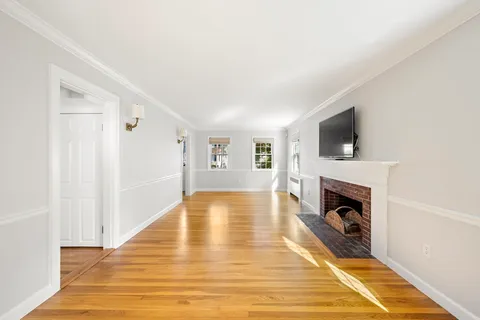 a living room with a flat screen tv and a fireplace