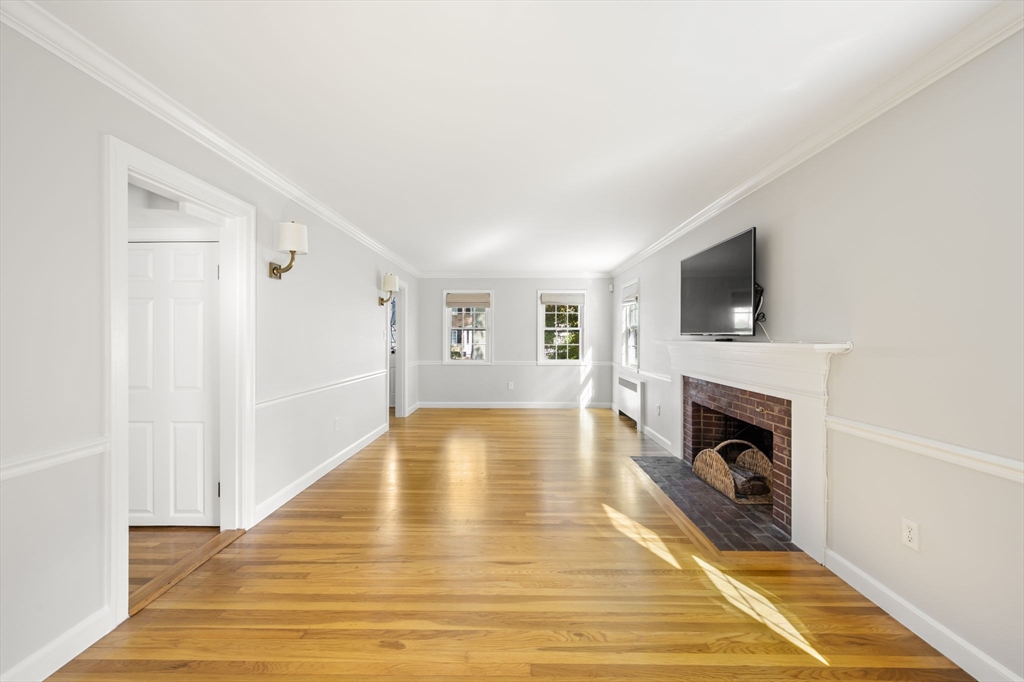 19 Lantern Lane Milton, MA 02186 - Photo 16 of 39 a view of livingroom with a fireplace wooden floor and staircase