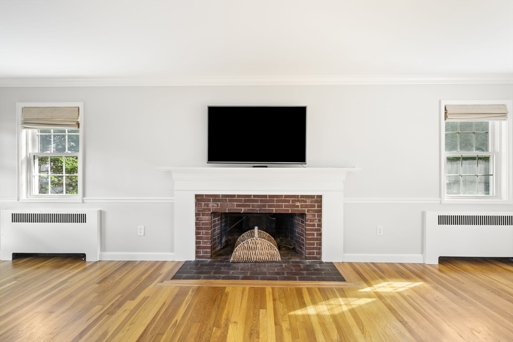 19 Lantern Lane Milton, MA 02186 - Photo 17 of 39 a living room with a flat screen tv and a fireplace