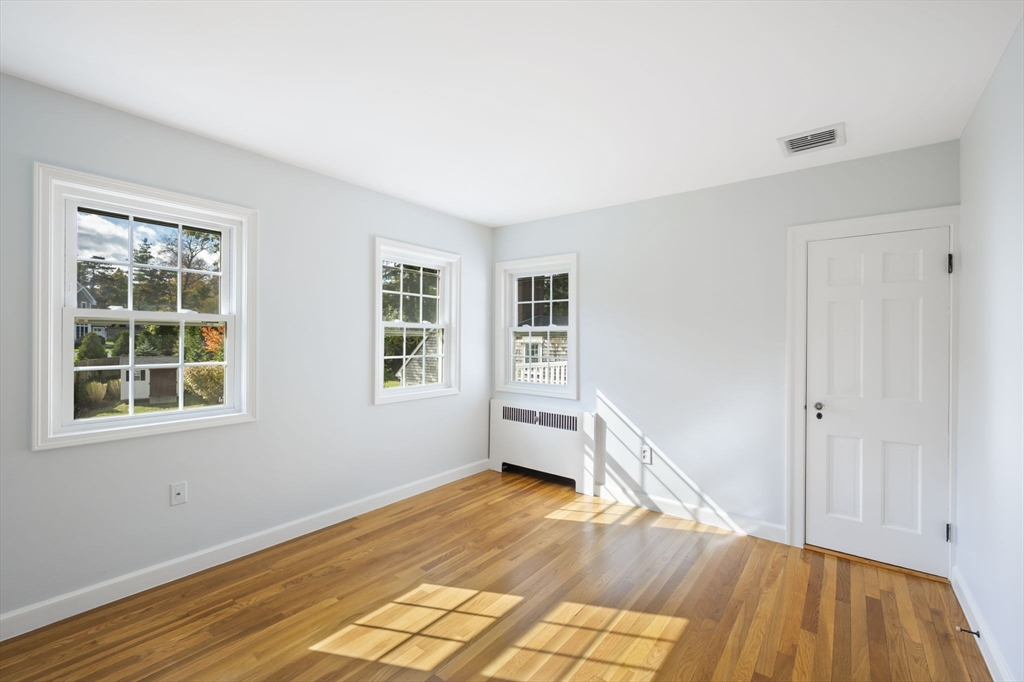 19 Lantern Lane Milton, MA 02186 - Photo 19 of 39 a view of empty room with wooden floor and fan