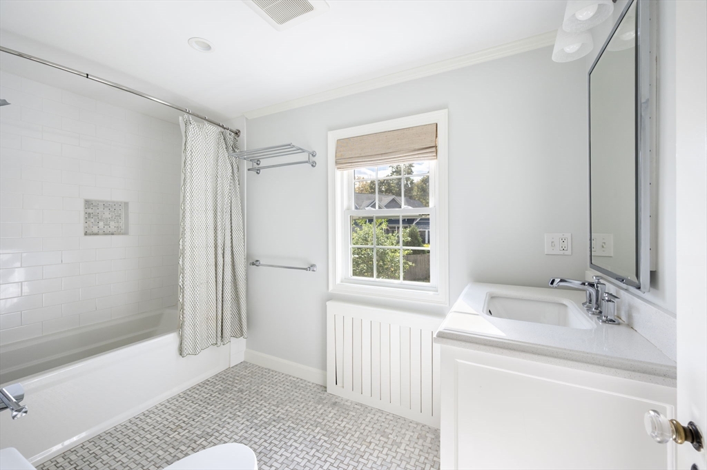 19 Lantern Lane Milton, MA 02186 - Photo 24 of 39 a bathroom with a sink a mirror and a shower