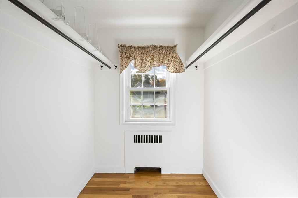 19 Lantern Lane Milton, MA 02186 - Photo 27 of 39 a view of an empty room with wooden floor and a window