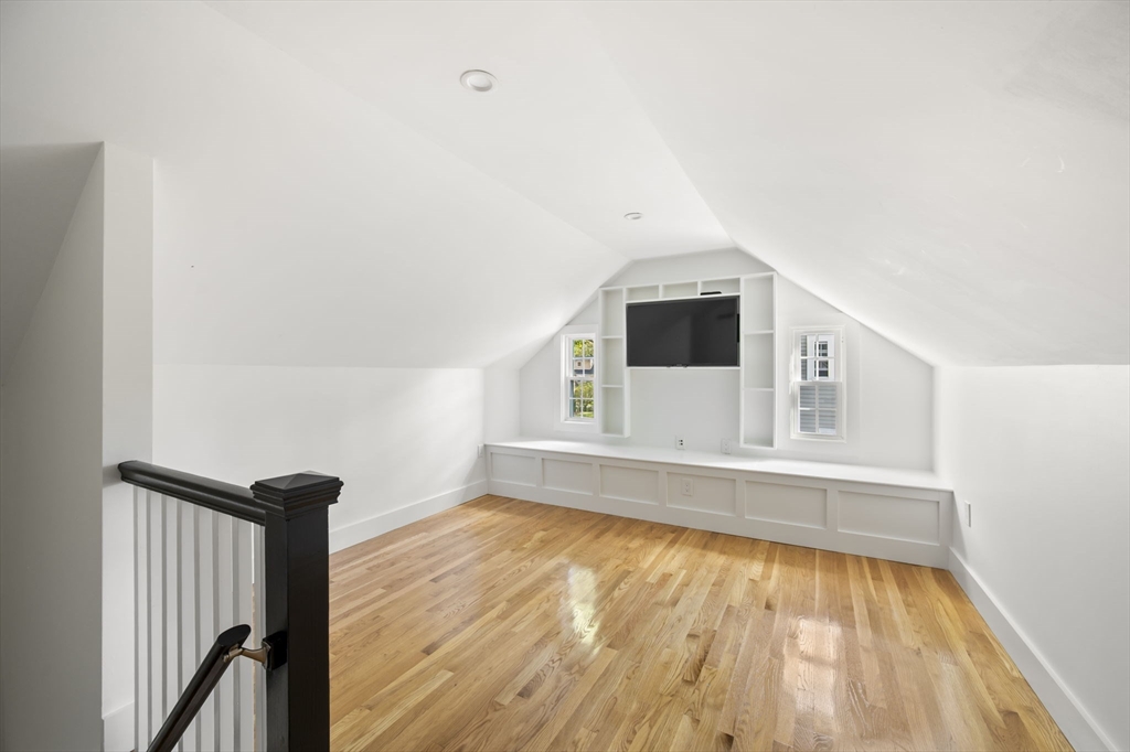 19 Lantern Lane Milton, MA 02186 - Photo 28 of 39 a view of an empty room with wooden floor and a window