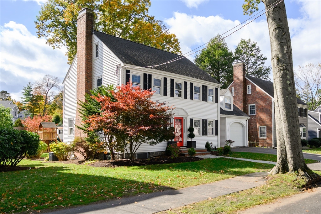 19 Lantern Lane Milton, MA 02186 - Photo 3 of 39 a front view of a house with a garden and trees