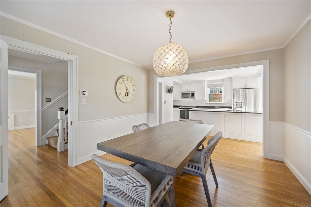 19 Lantern Lane Milton, MA 02186 - Photo 6 of 39 a view of a dining room and a kitchen with wooden floor