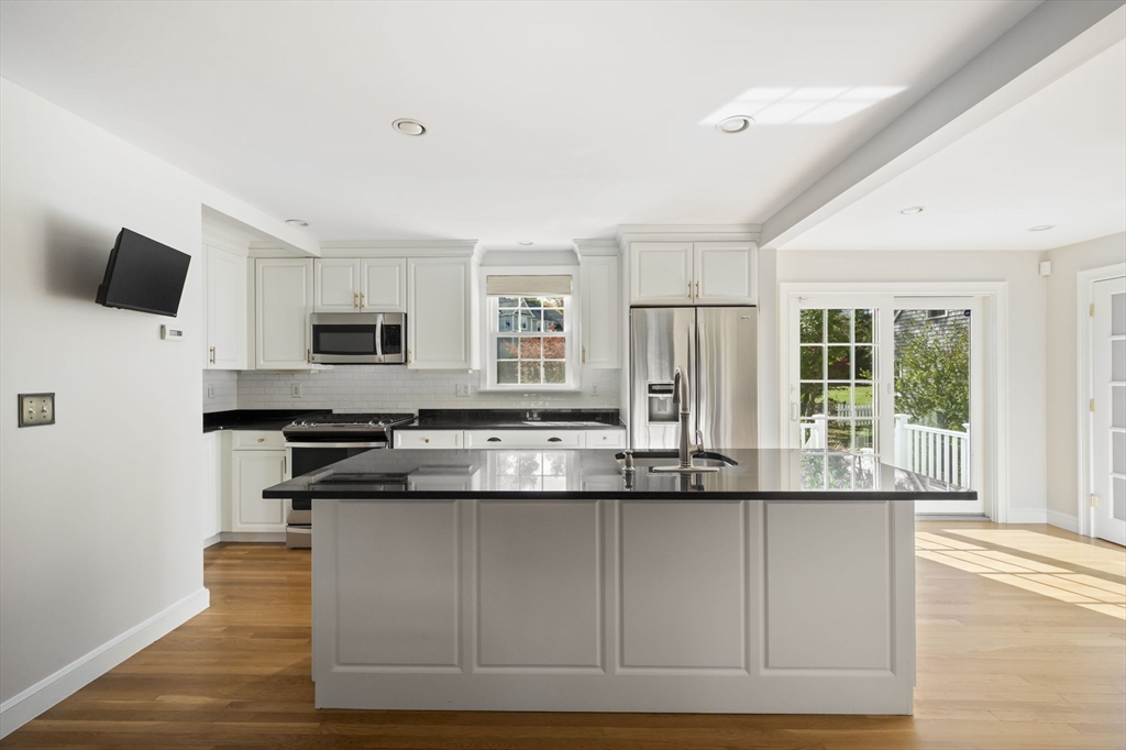 19 Lantern Lane Milton, MA 02186 - Photo 8 of 39 a kitchen with stainless steel appliances granite countertop a stove and a sink