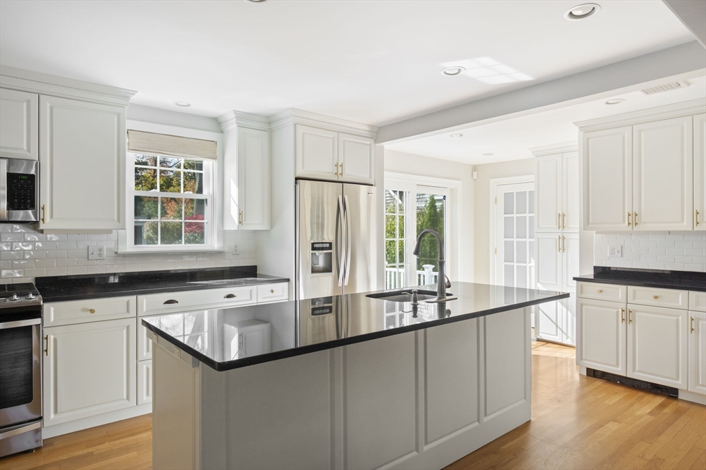 19 Lantern Lane Milton, MA 02186 - Photo 9 of 39 a kitchen with stainless steel appliances granite countertop a sink and cabinets