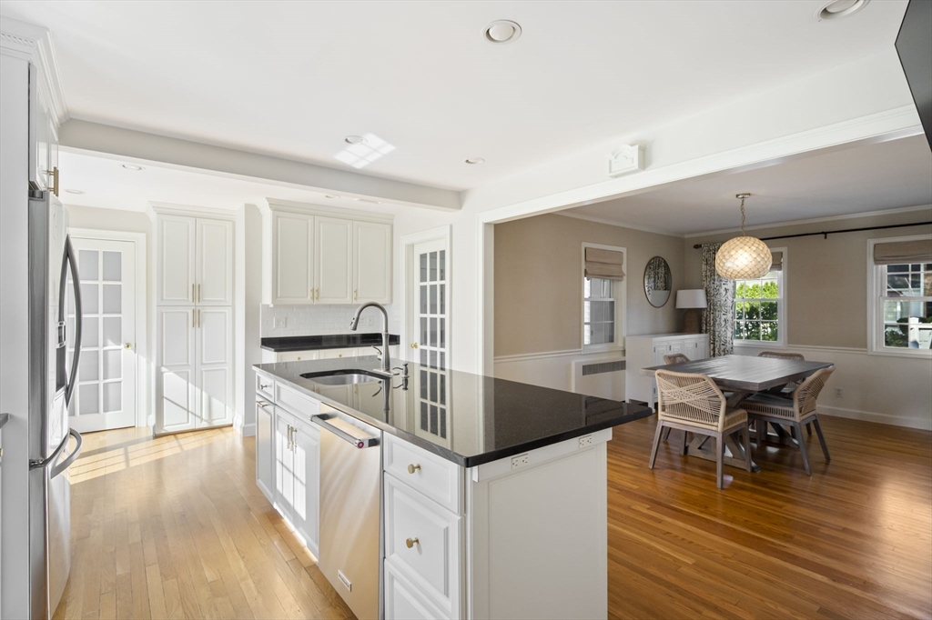 19 Lantern Lane Milton, MA 02186 - Photo 10 of 39 a kitchen with stainless steel appliances granite countertop a stove and a wooden floors