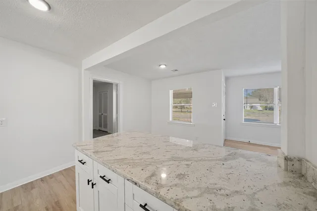 a view of a kitchen with a sink and cabinets