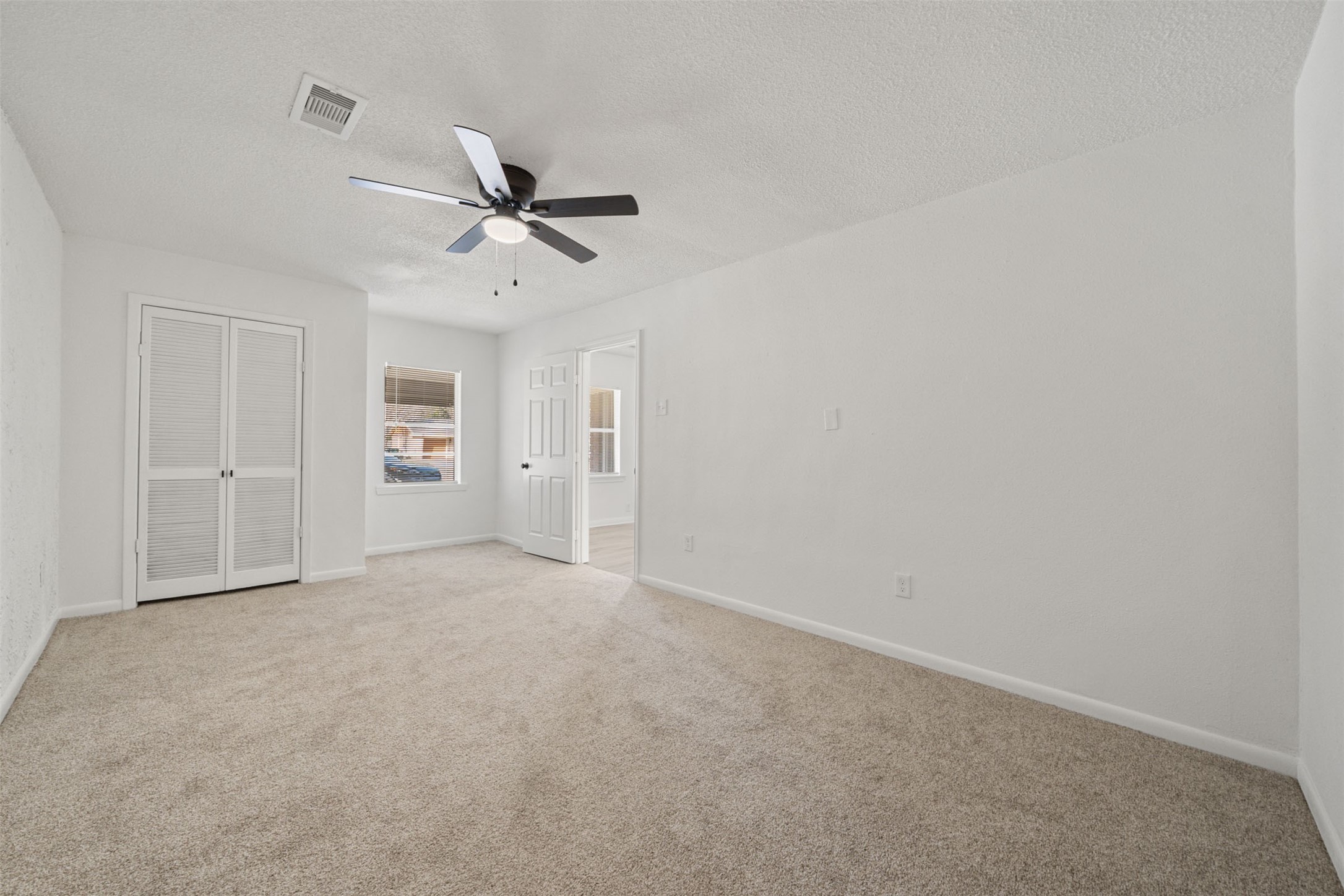 4601 West 43rd Street Houston, TX 77092 - Photo 18 of 40 an empty room with chandelier fan and windows