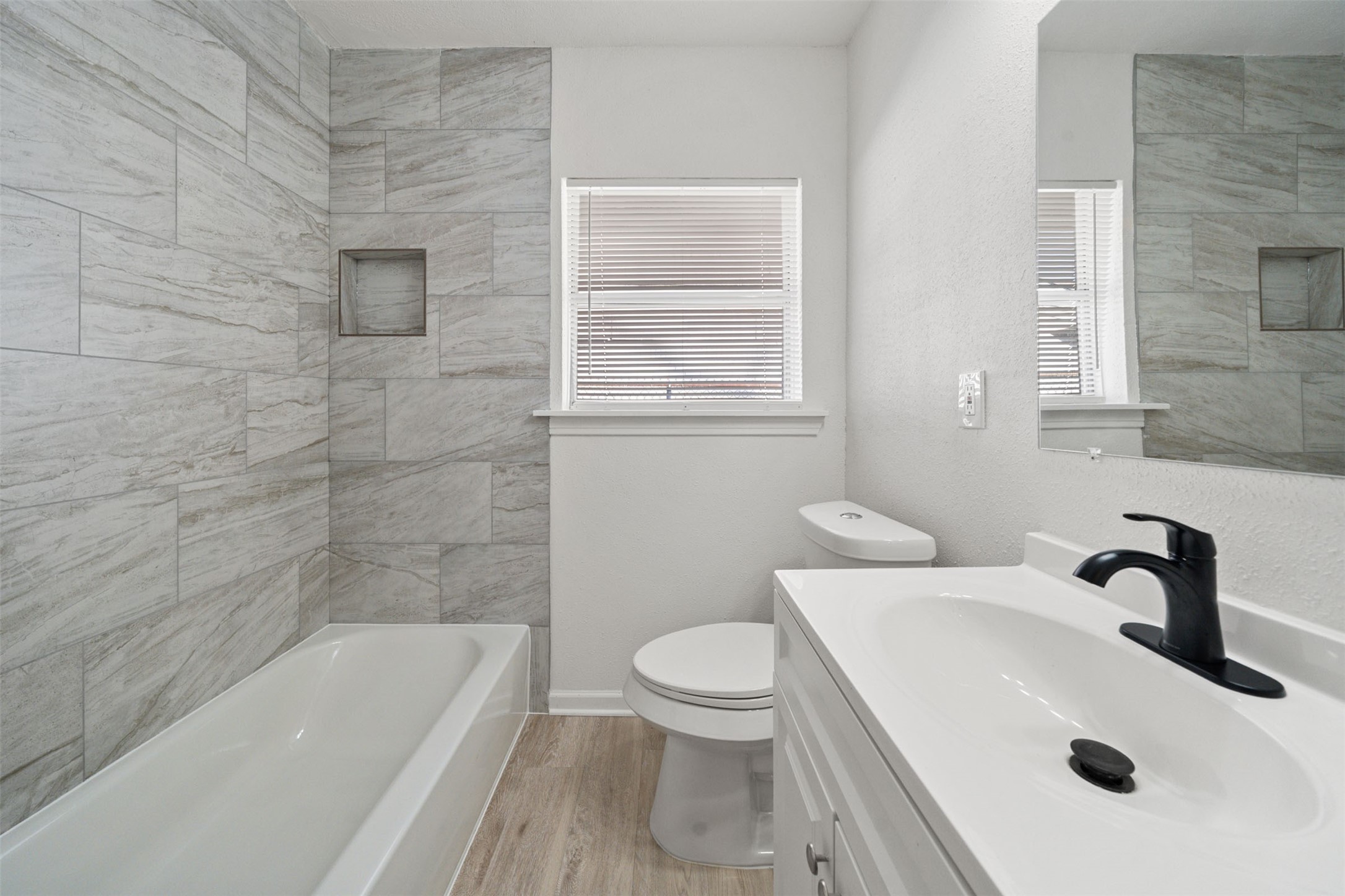 4601 West 43rd Street Houston, TX 77092 - Photo 22 of 40 a bathroom with a sink a toilet and bathtub