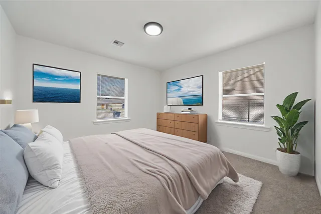 a bedroom with a large bed and a window