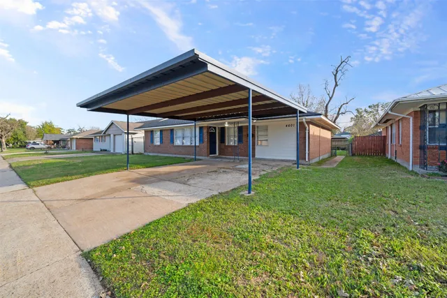 a yellow house sitting in middle of a yard