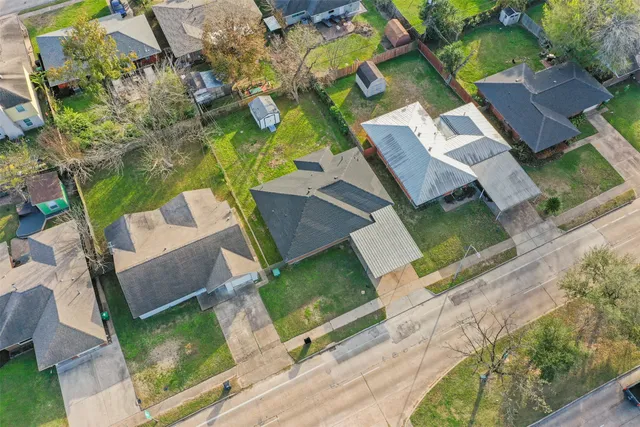 an aerial view of a house with a yard