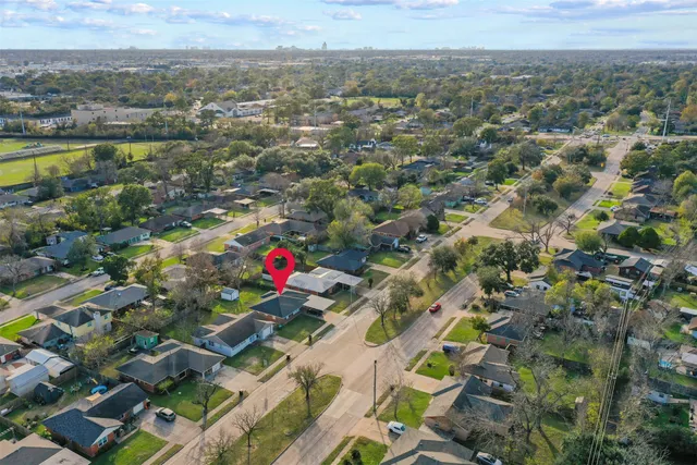 an aerial view of residential houses with outdoor space and swimming pool