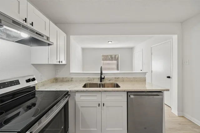 a kitchen with sink cabinets and window
