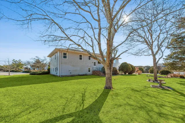a backyard of a house with lots of green space and fountain