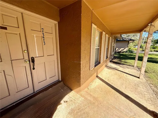 a view of a closet area with wooden floor