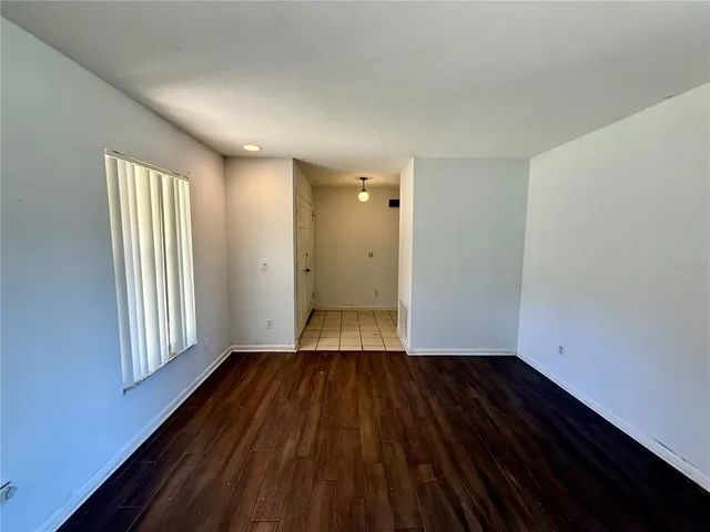 a view of a room with wooden floor and window