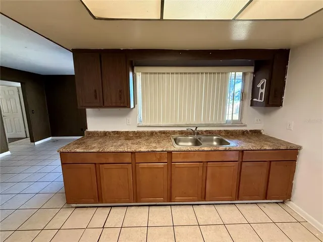 a view of a kitchen with stainless steel appliances granite countertop a sink and a stove