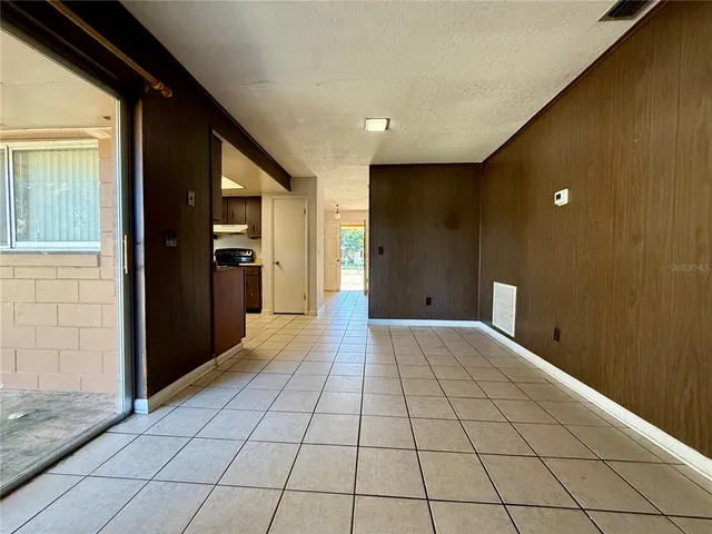a view of hallway with a window and kitchen view