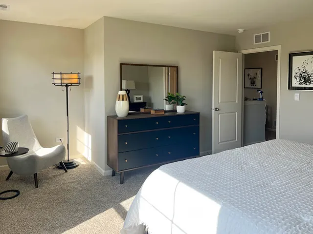 a bedroom with a bed and a mirror