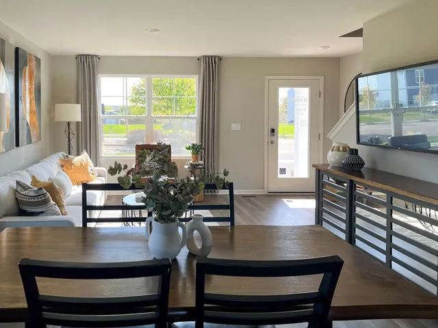 a view of a dining room with furniture a chandelier and wooden floor