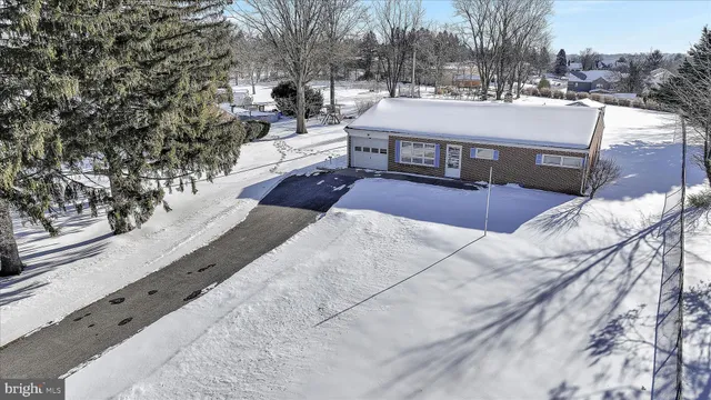 a view of a house with a yard and sitting area