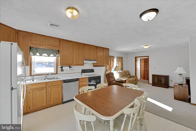 a large kitchen with a table and chairs