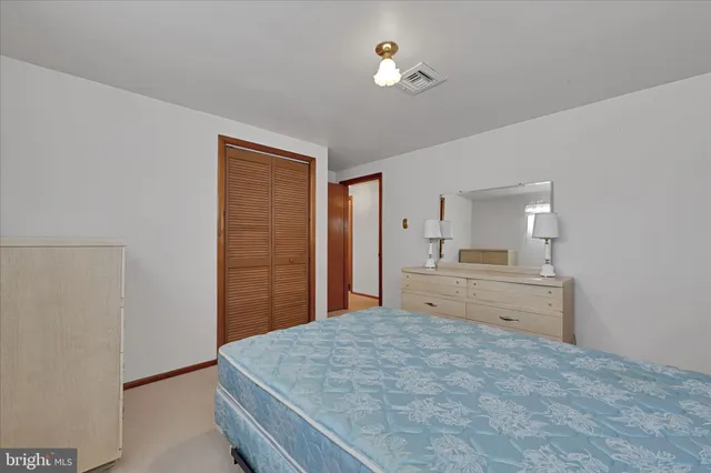 a large white bed in a white room