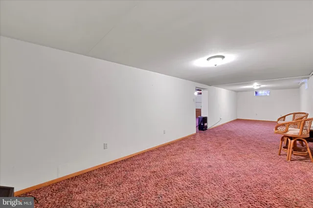 a view of a livingroom with a piano and wooden floor